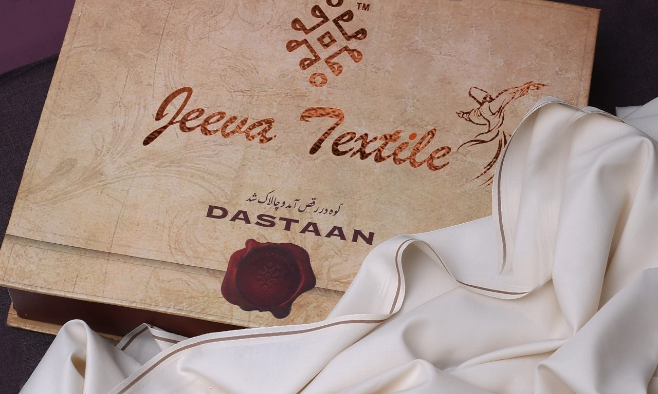 A yard of white fabric laid out with the brand name 'Wazir' visible on it, presented next to a branded box with the text 'Jeeva Textile - DASTAAN'.